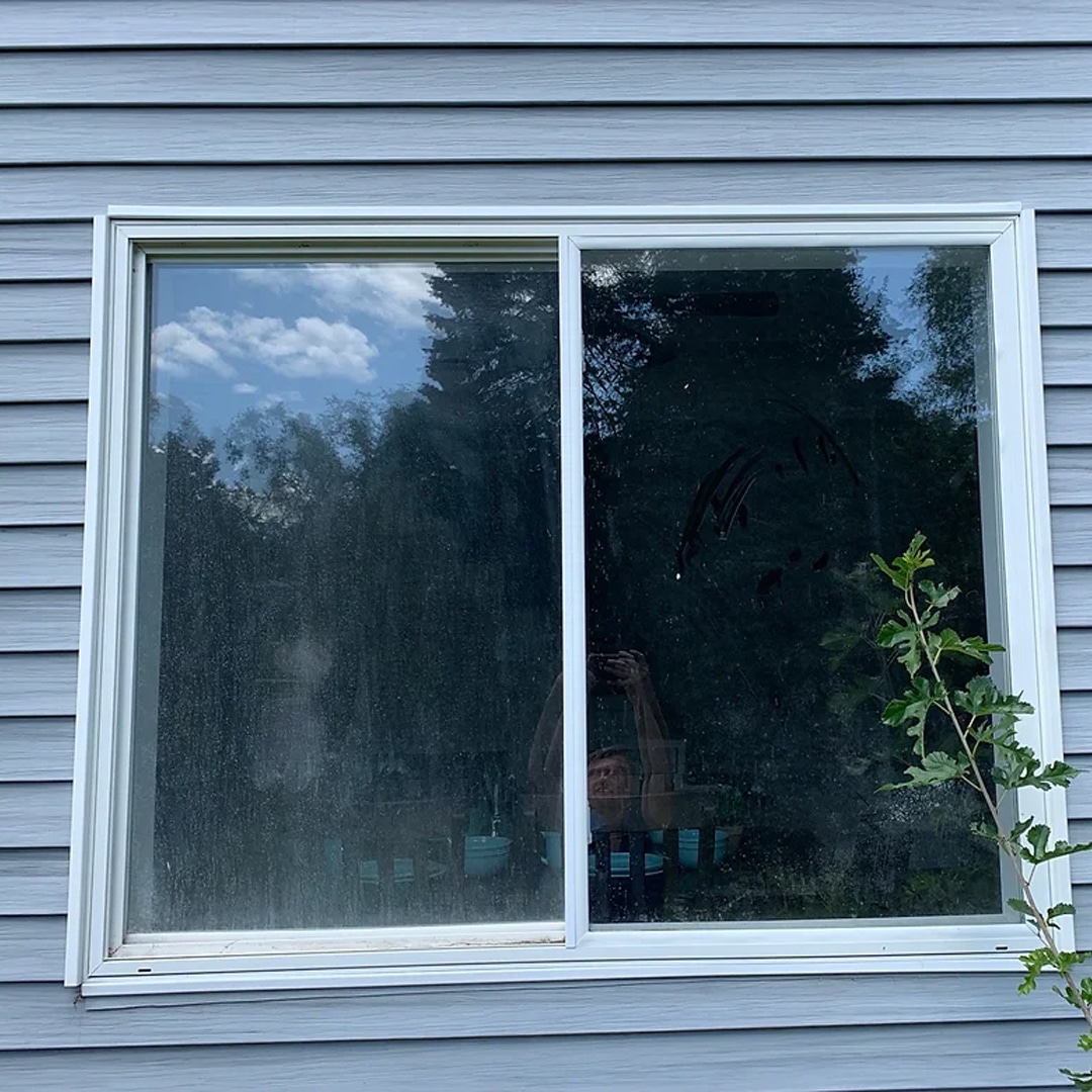 Before: residential window cleaning before and after Hudsonville MI sliding window